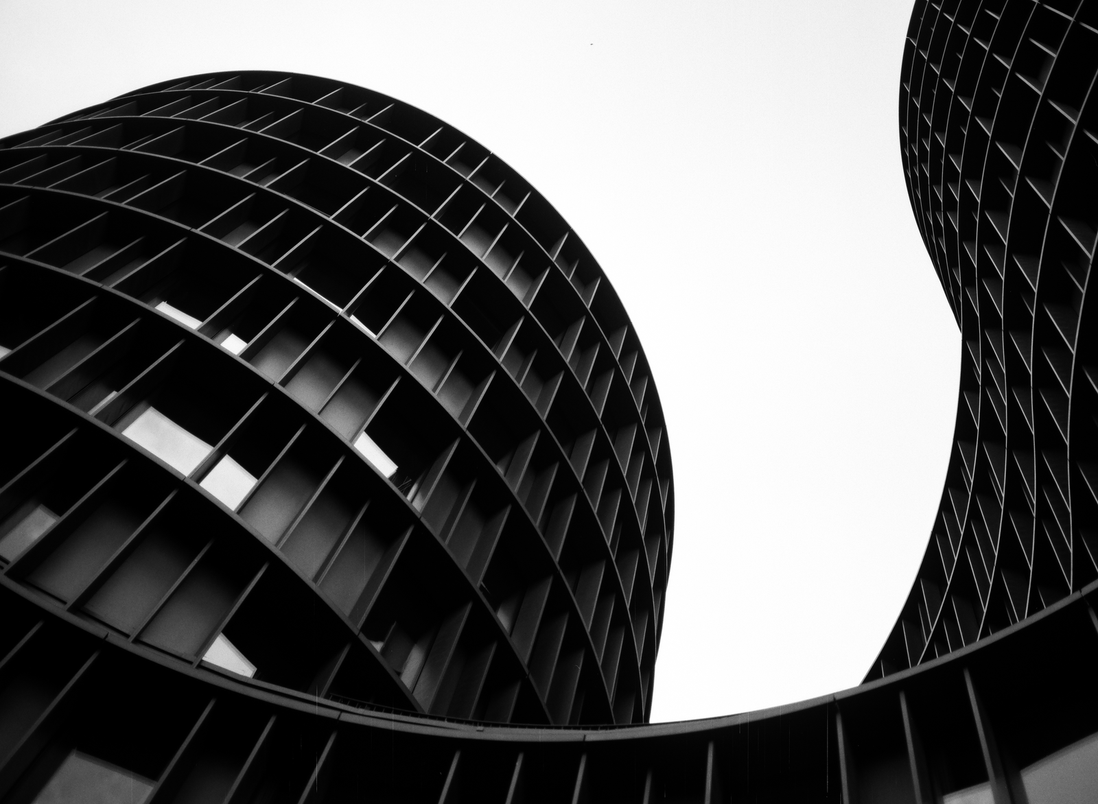black and white architectural curves against white sky