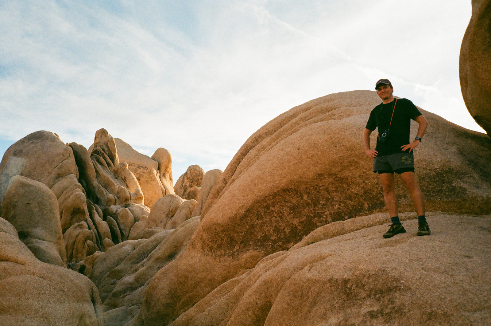 person standing among rounded desert boulders