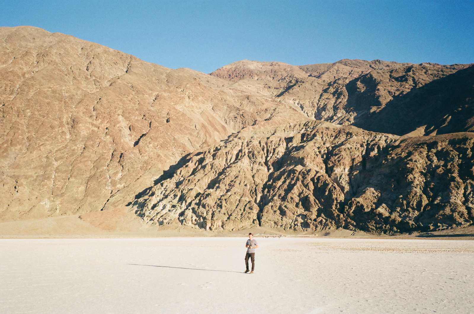 person photographed through a car window in a mountain valley