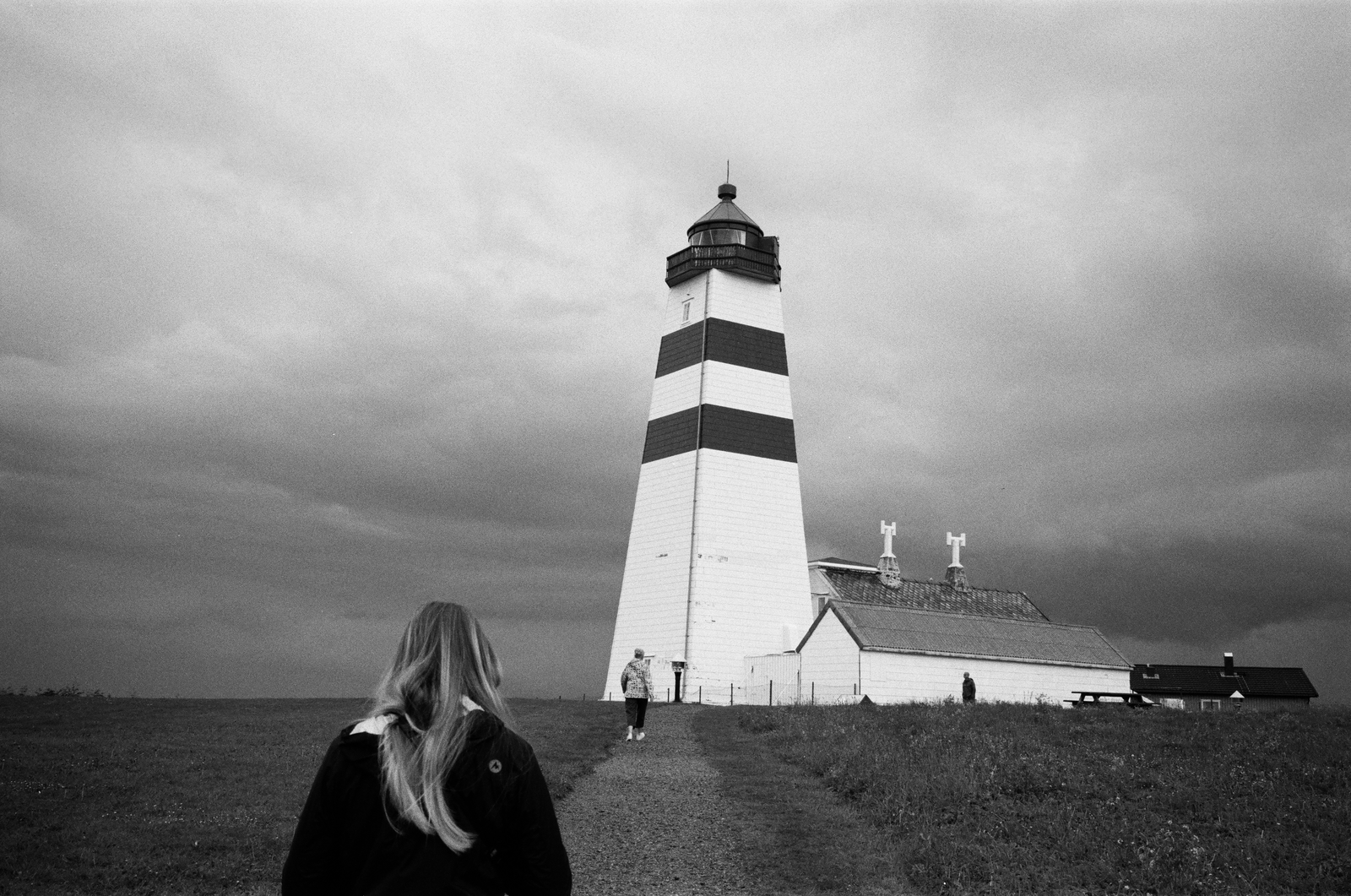 black and white lighthouse under a dark sky