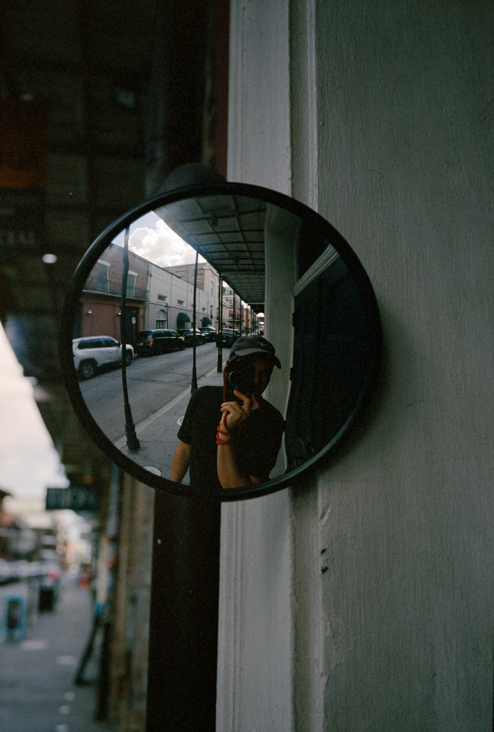 street reflected in a small round mirror